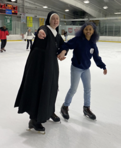 Sister and student ice skating